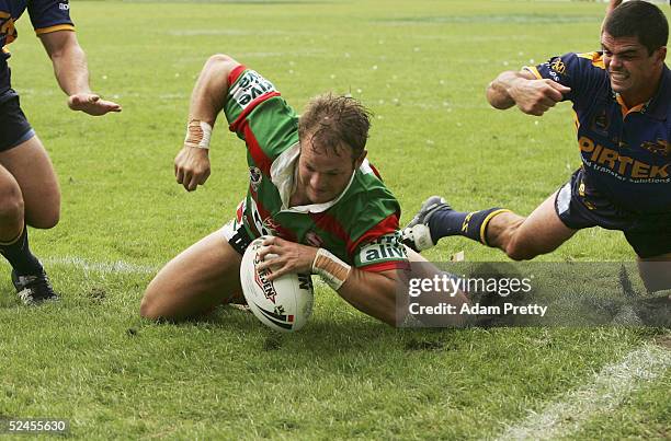 Luke MacDougall of the Rabbitohs goes in for a try while Daniel Wagon of the Eels misses the tackle during the NRL round 2 match between the South...