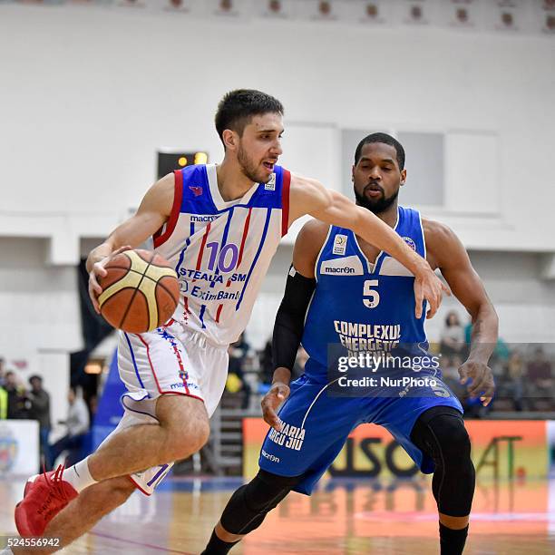 Nikola Malesevic of Steaua CSM EximBank Bucharest and Porter Silvanus Troupe of CS Energia Targu Jiu in action during the LNBM - Men's National...