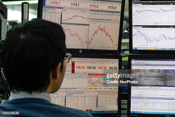 Dec 16, 2015 - South Korea, Seoul : Currency dealers work in front of quote screens at the trading room of KEB Hana Bank's headquarters in Seoul,...