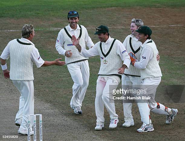 The Australians celebrate after Shane Warne of Australia caught Nathan Astle of New Zealand off Michael Clarke's bowling during day three of the 2nd...