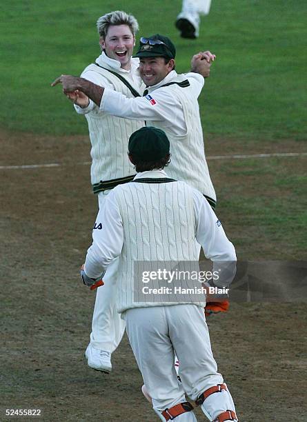 Michael Clarke and Ricky Ponting of Australia celebrate the wicket of Nathan Astle of New Zealand during day three of the 2nd Test between New...