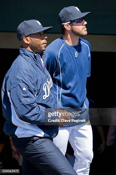 Former Detroit Tiger Craig Monroe and studio analyst on Fox Sports Detroit, watches the score board next to Justin Verlander of the Tigers in the...