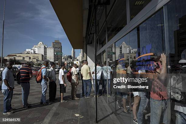 Job seekers wait in line to enter the Centro Apoio ao Trabalho government unemployment center in Sao Paulo, Brazil, on Monday, April 25, 2016. Brazil...