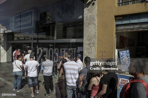 Job seekers wait in line to enter the Centro Apoio ao Trabalho government unemployment center in Sao Paulo, Brazil, on Monday, April 25, 2016. Brazil...