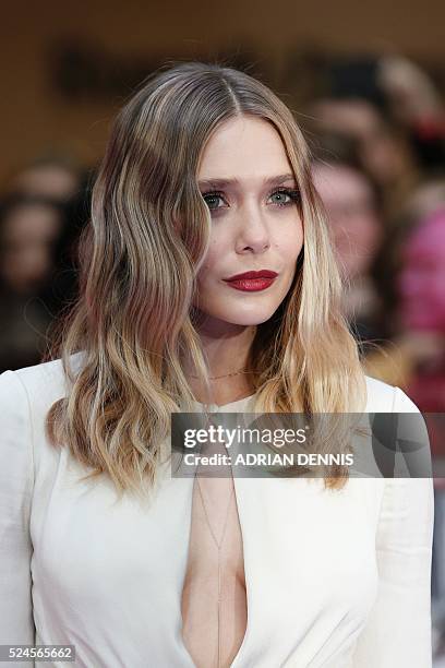 Actress Elizabeth Olsen poses on the red carpet arriving for the European Premiere of the film Captain America: Civil War in London on April 26, 2016...