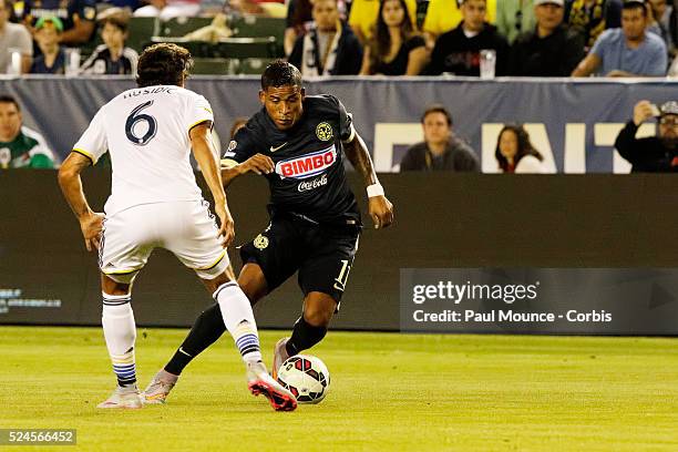 Michael Arroyo of Club America makes a move against Baggio Husidic of the Los Angeles Galaxy during the Los Angeles Galaxy vs Club America match of...