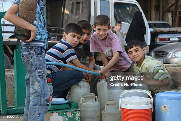 Eastern Ghouta, Syria, on july 13, 2015. Children fill their jerry from the well and waiting for their turn to come due to congestion The suffering...