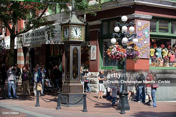 Tourists gather to watch the steam clock on Water Street, which blows steam every 15 minutes, in Gastown, Vancouver.