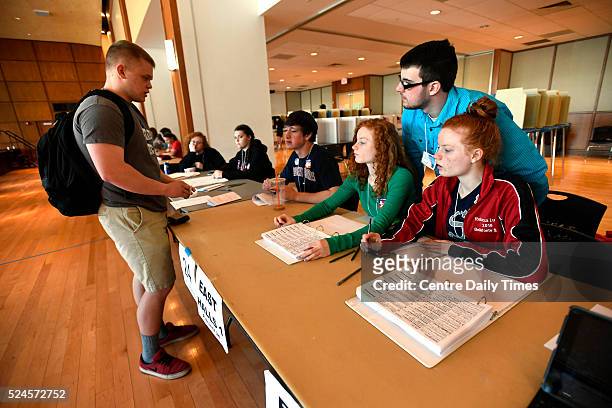 Bellefonte Area High School students Annie Lucas, middle, Becky Lucas, right, and Cody Allison, top, check in Penn State student Jarrett Patterson to...