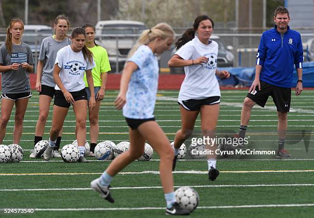 Broomfield High School girls soccer coach Jim Davidson, right, watches a drill during a short practice at the school on Monday, April 25, 2016....