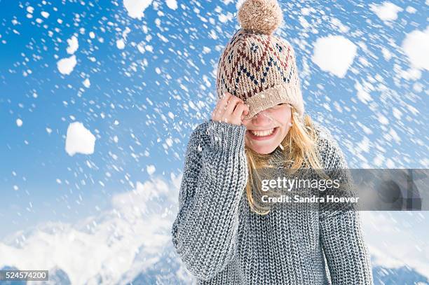 young woman hiding under her cap - hiding from selfie stockfoto's en -beelden