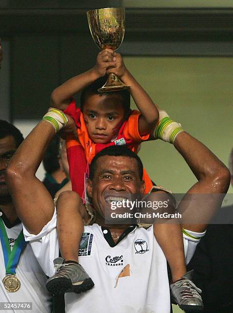 Waisale Serevi of Fiji and son Serevi Jr. Hold aloft the Melrose Cup after defeating New Zealand in the Cup Final on day three of the Rugby World Cup...