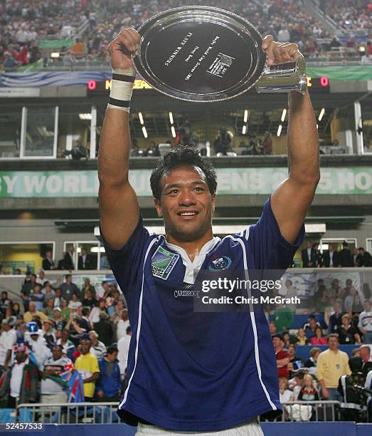 Brian Lima of Samoa holds aloft the Plate after defeating Portugal in the Plate Final on day three of the Rugby World Cup Sevens held at Hong Kong...