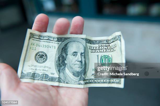 December 13, 2012 - $100 Dollar bill of John Mcafee used to buy supplies. John McAfee talks to the media at the Beacon Hotel where he is staying...