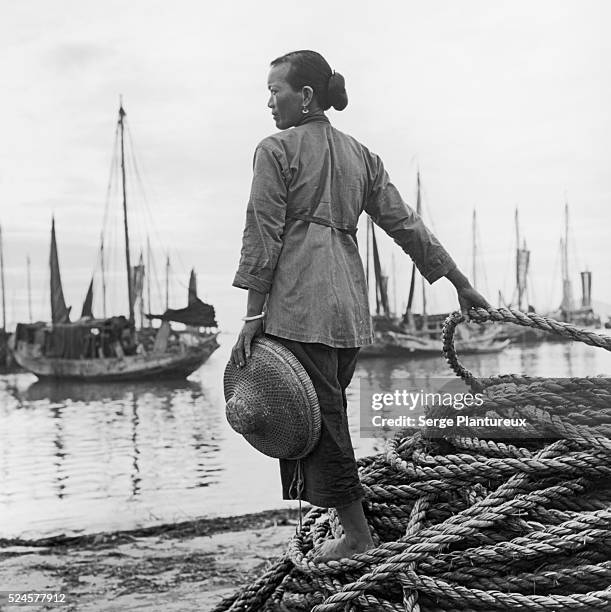 Woman overlooking harbor, China, 1956