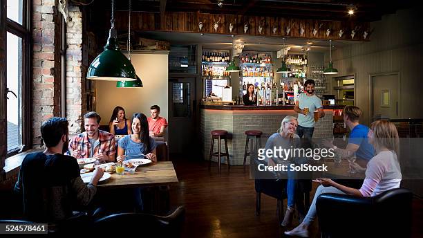 busy bar scene - friends in restaurant bar stockfoto's en -beelden