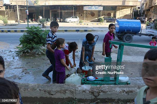 Eastern Ghouta, Syria, on july 13, 2015. Children fill their jerry from the well and waiting for their turn to come due to congestion The suffering...