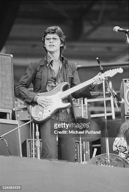Canadian singer-songwriter and guitarist Robbie Robertson performing with rock group The Band, at Wembley Stadium, London, 14th, September 1974. The...