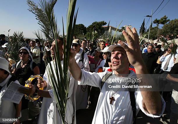 French Catholic pilgrims sing hymns during the traditional Palm Sunday procession on the Mount of Olives at the start of Holy Week March 20, 2005 in...
