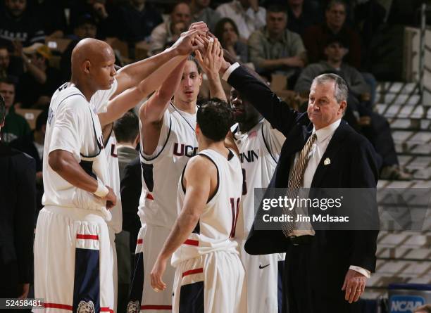 Coach Jim Calhoun of the Connecticut Huskies puts his hand up wiht his team during a game against the N.C. State Wolfpack in the second round of the...