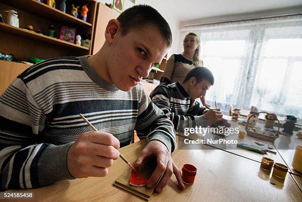 Boys with mental disorders paint their sculptures made of salt dough, Teterivka's Orphanage and Boarding school. Zhytomyr, Ukraine. 2 of February,...