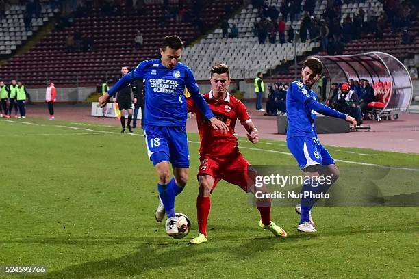 Steliano Filip of Dinamo Bucharest, Bogdan Ungurusan and Mihai Cosmin Radut of CS Pandurii Targu Jiu in action during the League Cup Adeplast game...