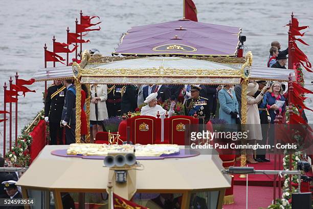 Queen Elizabeth II aboard the Royal Barge Spirit of Chartwell heads the historic flotilla of 1000 boats along the Thames river past the Houses of...