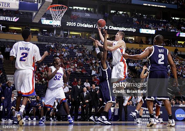 David Lee of the Florida Gators goes through Will Sheridan of the Villanova Wildcats on his way to the basket in the second round of the NCAA...