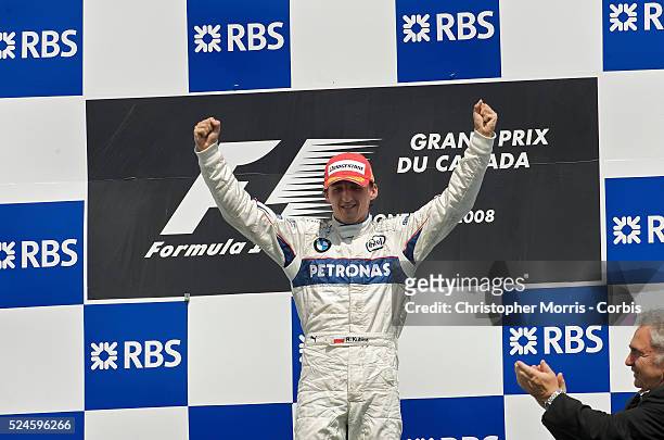 Sauber team race car driver Robert Kubica raises his arms in victory on the podium after winning the Formula One Grand Prix of Canada at the Gilles...