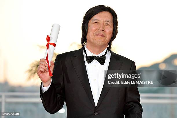 Chang-Dong Lee with his award of Best Screenplay at the photo call for "The Palme d'Or Award Ceremony? during the 63rd Cannes International Film...