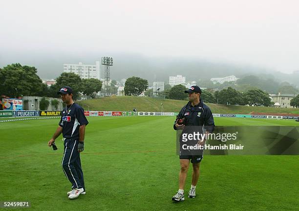 Ricky Ponting of Australia and assistant coach Dene Hills leave the field as fog and rain roll in and delay the start of play during day four of the...