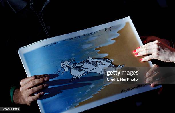 Several people holding a drawing of Aylan during the Demonstration in support to World refugee day in Madrid on September 12, 2015.