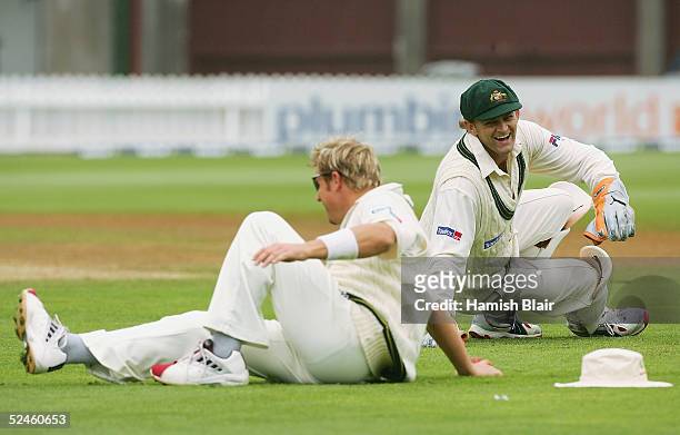 Adam Gilchrist of Australia laughs as team mate Shane Warne slips on the wet grass during day four of the 2nd Test between New Zealand and Australia...