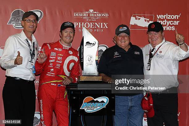 Scott Dixon of New Zealand, driver of the Target Chip Ganassi Racing Chevrolet IndyCar poses with A. J. Foyt and Chip Ganassi after winning the...