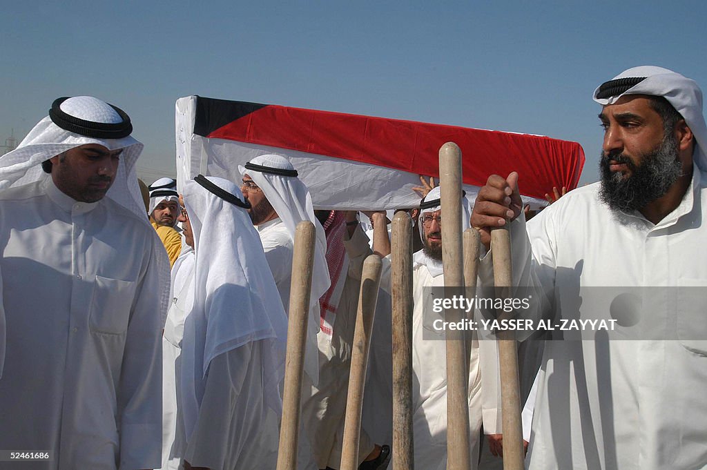 Reletives carry the coffin of one of sev