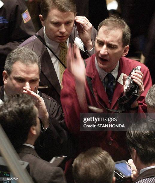 Stock traders work the floor of the New York Stock Exchange just after the opening bell, 21 March, 2005. Wall Street shares opened mixed 21 March as...