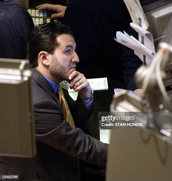Stock specialist watches a monitor on the floor of the New York Stock Exchange just before the opening bell, 21 March, 2005. Wall Street shares...