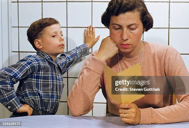 Disappointed Mother Reading Son's Report Card