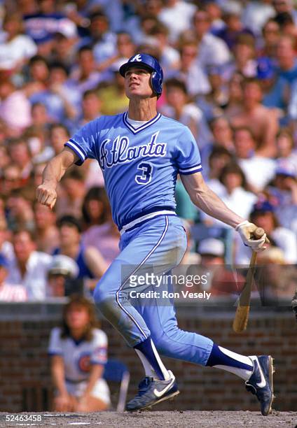 Dale Murphy of the Atlanta Braves watches the flight of the ball as he follows through on his swing during a game against the Chicago Cubs in 1986 at...