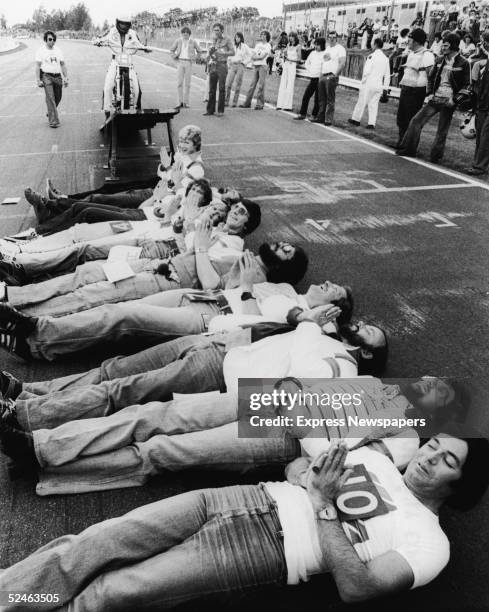 British daredevil Eddie Kidd prepares to jump ten Radio One disc jockeys lain out upon the ground in a line with his motorcycle, Brand's Hatch racing...