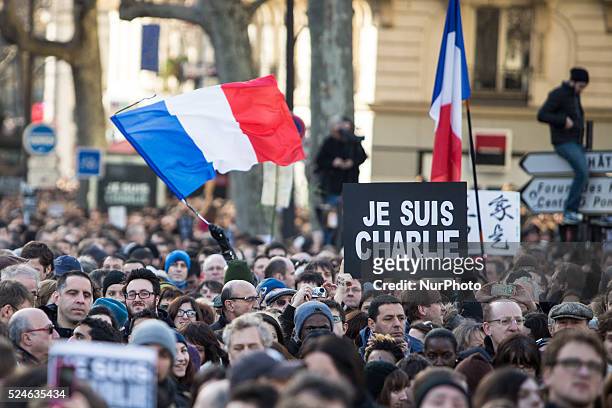 People holding cardboards reading &quot;Je suis Charlie take part in a Unity rally "Marche Republicaine" on the Place de la Republique in Paris on on...