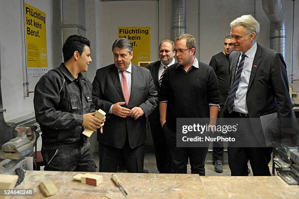 Energy Minister Sigmar Gabriel departs after visiting a cabinet-making tradecrafts exposure program for migrants and refugees at the Arrivo center on...