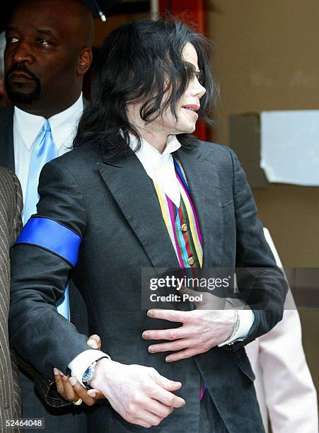 Pop star Michael Jackson emerges from the Santa Barbara County Courthouse March 21, 2005 in Santa Maria, California. The trial was delayed 45 minutes...