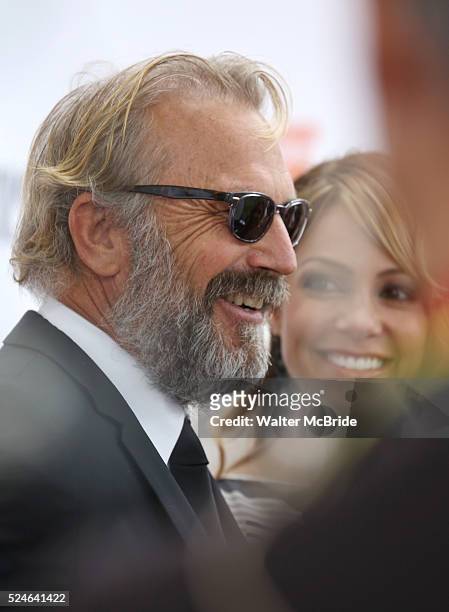 Kevin Costner and wife Christine Baumgartner arrives at the 'Black and White' premiere during the 2014 Toronto International Film Festival at Roy...