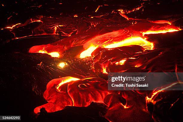 detail of glowing molten lava flow at night. - kalapana stock pictures, royalty-free photos & images