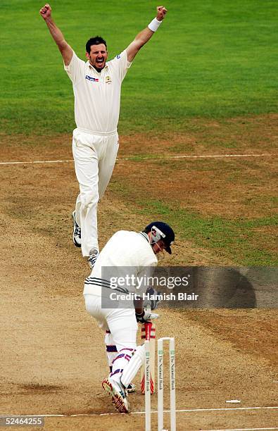 Michael Kasprowicz of Australia celebrates the wicket Lou Vincent of New Zealand his 100th Test wicket during day five of the 2nd Test between New...