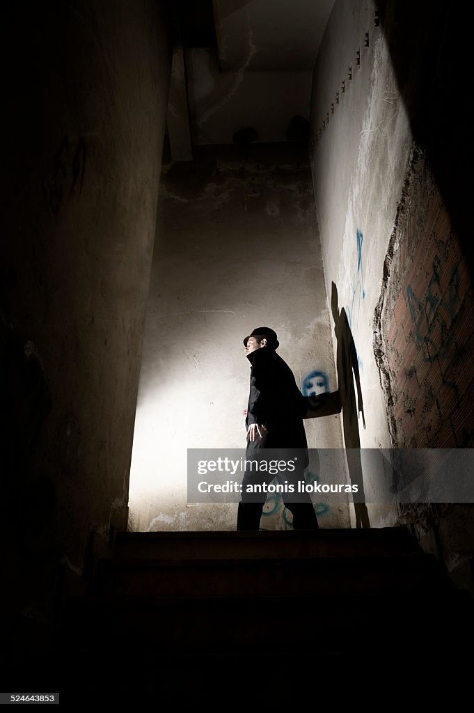 Man in a dark abandoned building