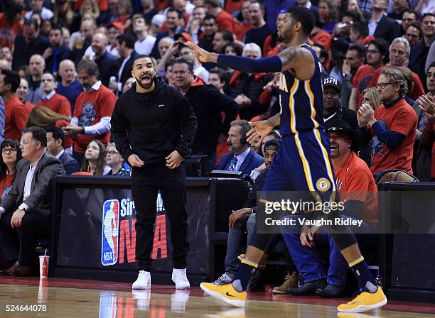 Singer Drake shouts at Paul George of the Indiana Pacers in the first half against the Toronto Raptors of Game Five of the Eastern Conference...