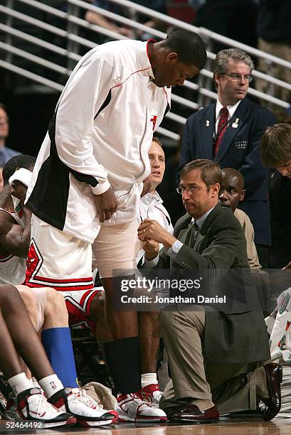 Eddy Curry of the Chicago Bulls has his strained hamstring wrapped by trainer Fred Tedeschi at the end of a game against the Atlanta Hawks on March...