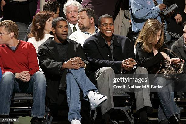 Actor Denzel Washington and television personality Ahmad Rashad watch the game between the San Antonio Spurs and the New York Knicks on March 21,...